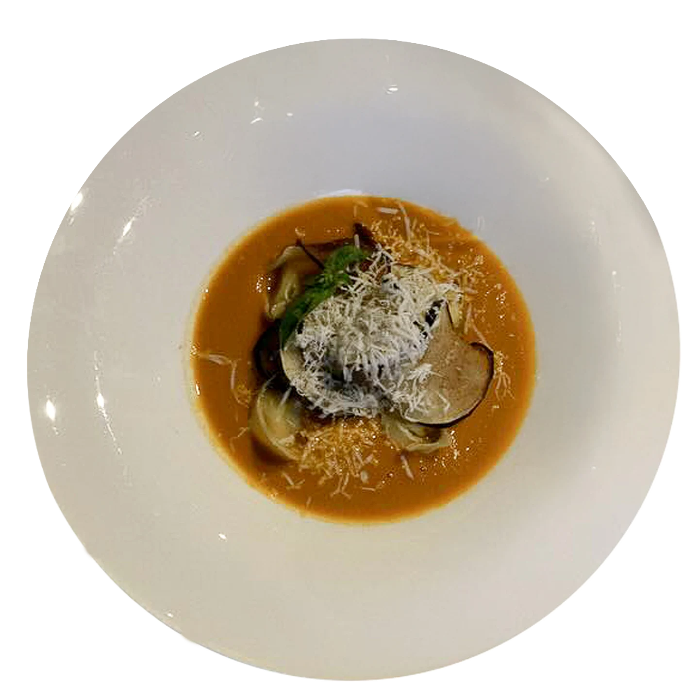 Aubergine tortelli with three-colour tomato cream and pecorino cheese shavings, a dish from the Da Alcide restaurant in Venturina, Tuscany.