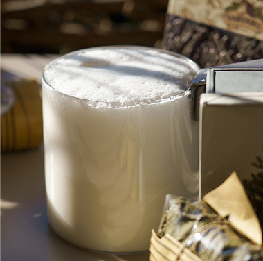 Glass cup with whipped milk for breakfast.