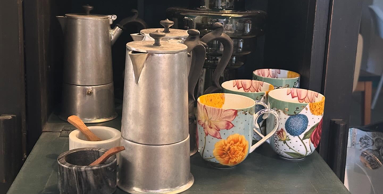 Caffettiere, tazzine da caffè dipinte e ciotole in marmo, oggettistica selezionata dalla bottega del ristorante Da Alcide a Venturina, in Toscana. Foto di Laura Scatena